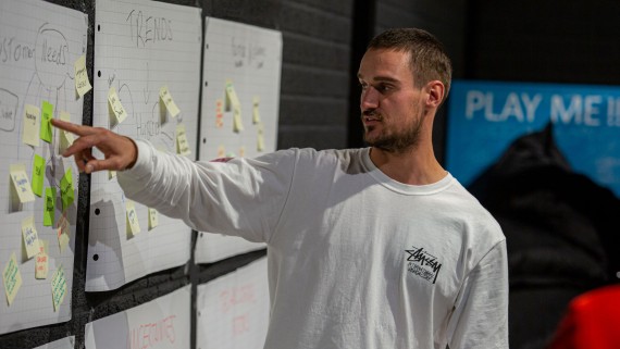 Een student wijst een post-it aan 