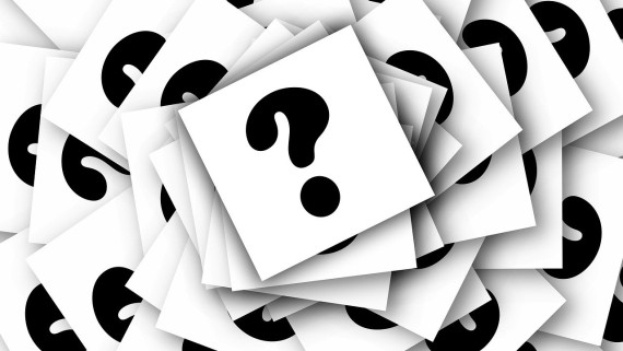 Zwarte vraagtekens op een witte achtergrond