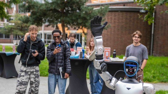 people taking a picture of a robot