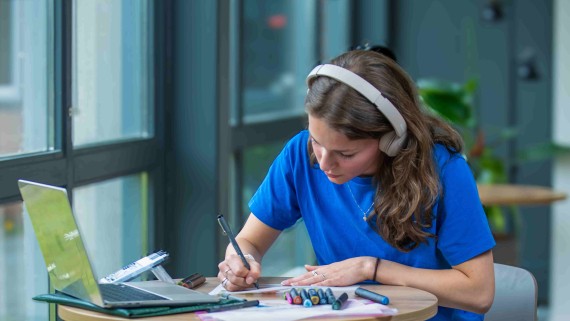 student working focussed with headphones