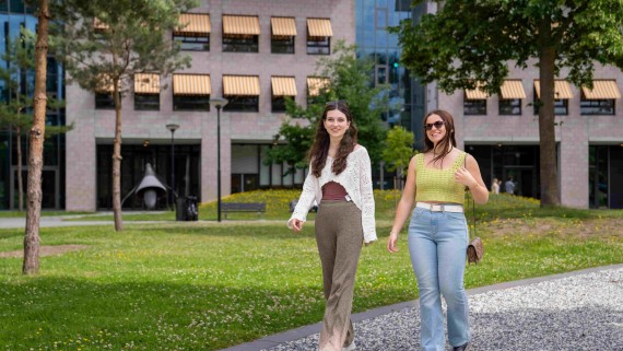 two people walking on gravel path