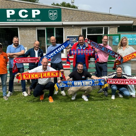 Groepsfoto van mensen met sjaals van voetbalclubs