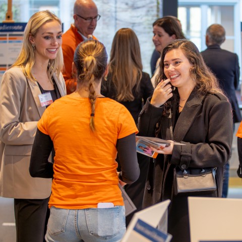 Twee vrouwen praten met een student op de BUas open dag