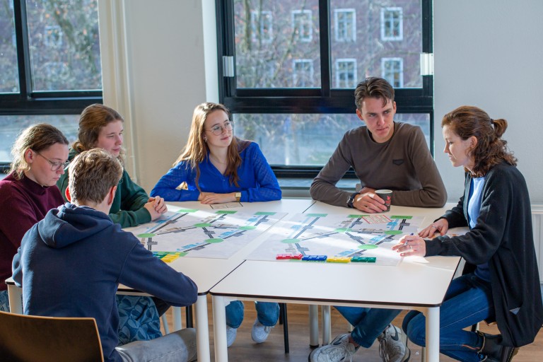 Studenten werken samen aan een tafel