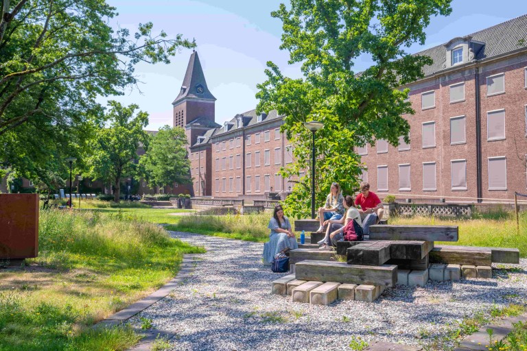 students outside in green environment or campus