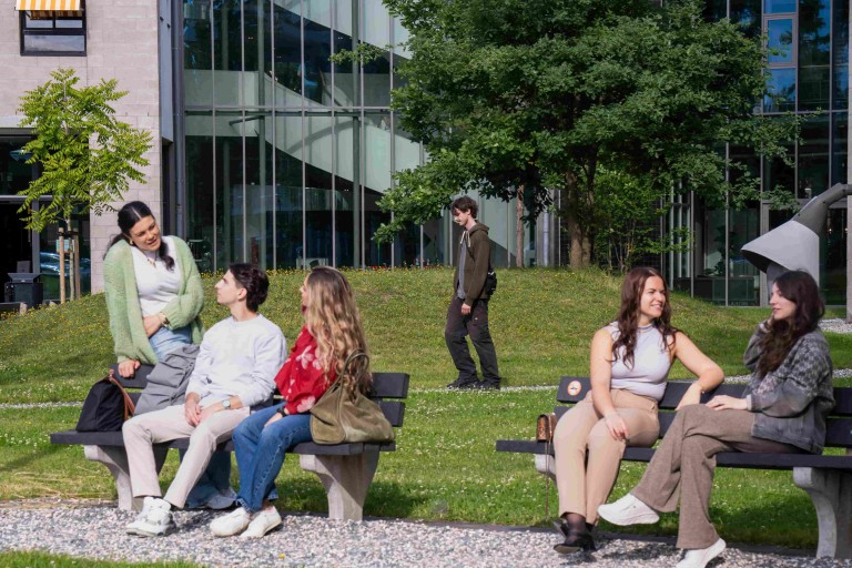 students sitting outside and talking