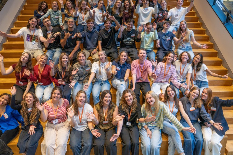 group picture with students waving in the air