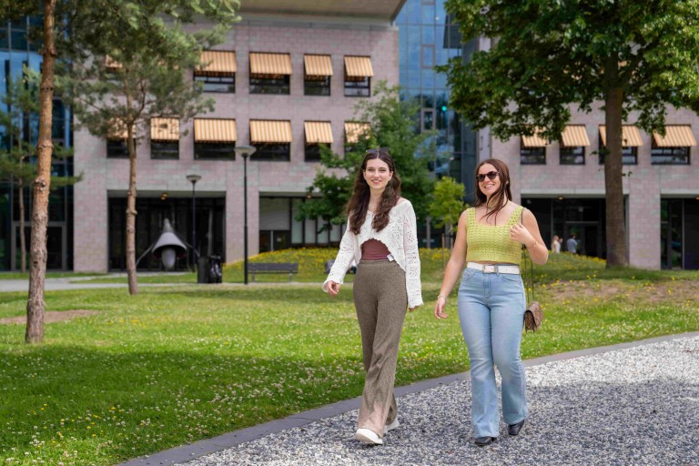 two people walking on gravel path