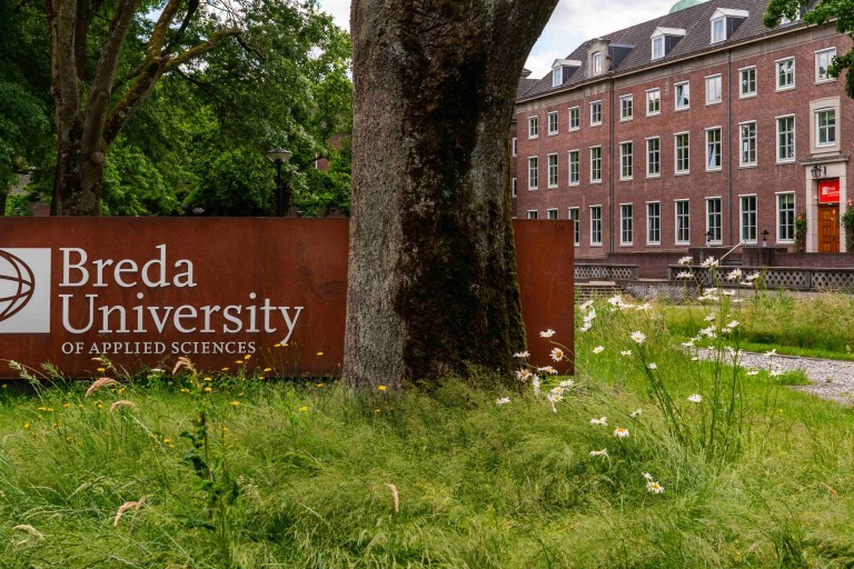 logo in grass area with tree