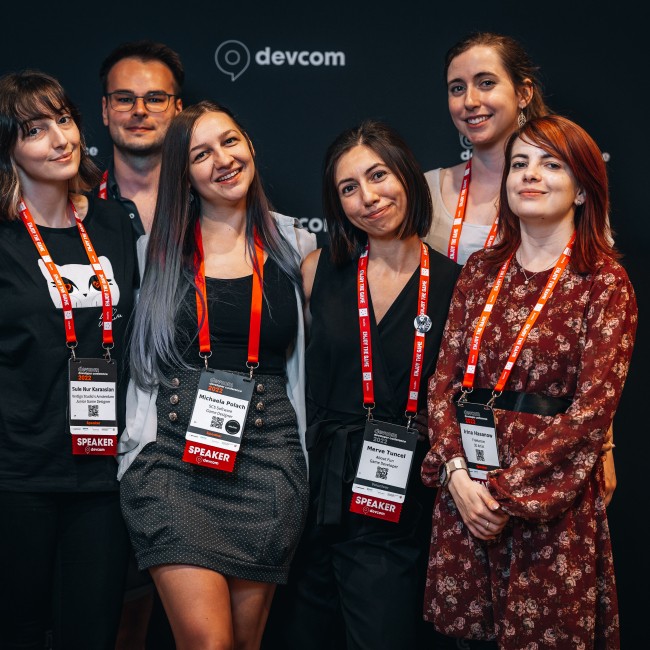 Groepsfoto van zes studenten op de Devcom conferentie