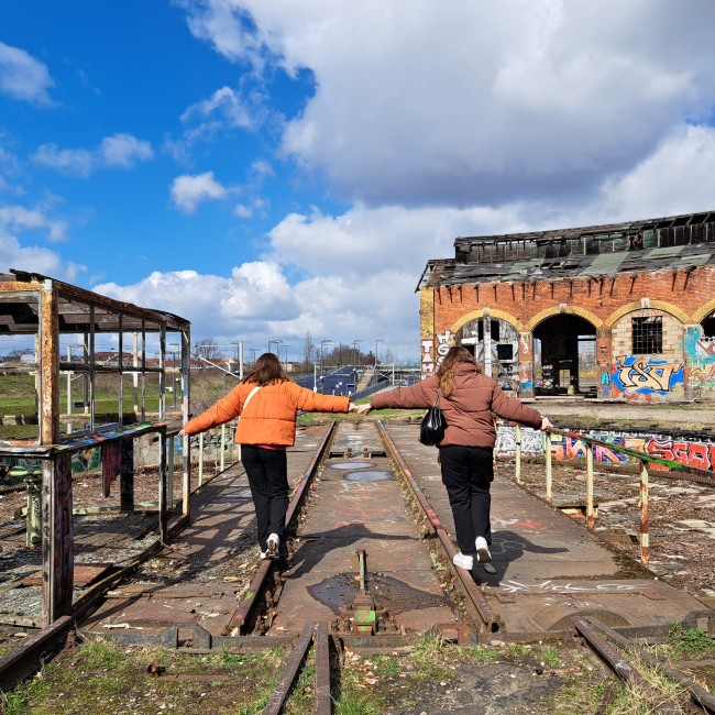Meisjes lopen over vervallen industrieel terrein