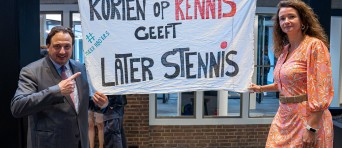 Jorrit Snijder en een vrouw staan bij een spandoek