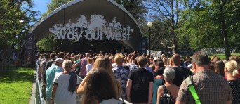 Mensen staan in rijen bij de ingang van een festival